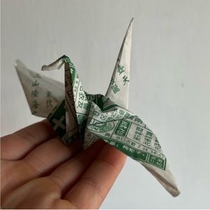 20 handmade paper cranes made out of Chinese horoscope paper